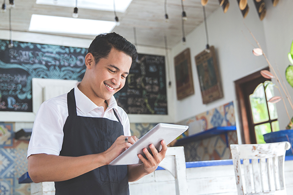 Restaurant employee holding a tablet